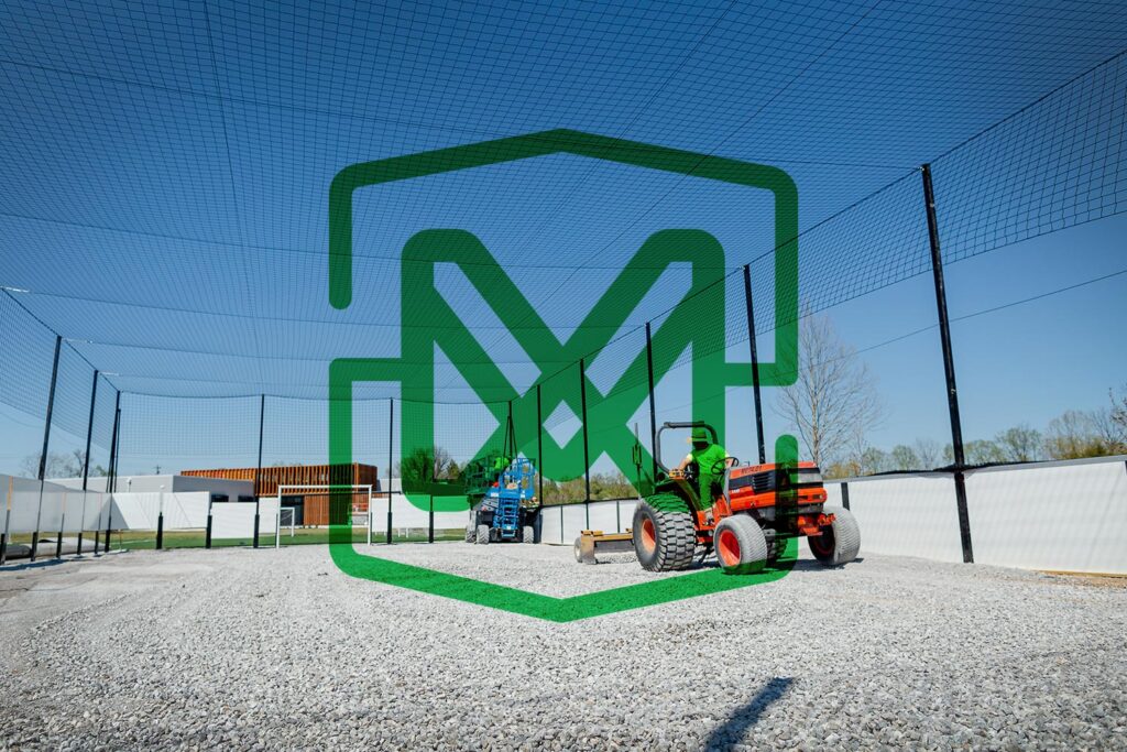 outdoor playing surface being built with the Motz logo mark